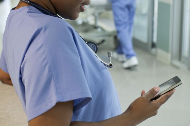 Female-nurse-using-smartphone